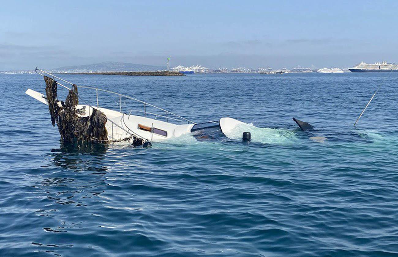 Two people and two dogs were rescued from a 65-foot-long powerboat that crashed into the Long Beach breakwater late Wednesday night, July 14, with an additional dog missing and presumed dead, a fire official said. The boat, pictured on Thursday morning, had severe damage. (Long Beach Fire Department)