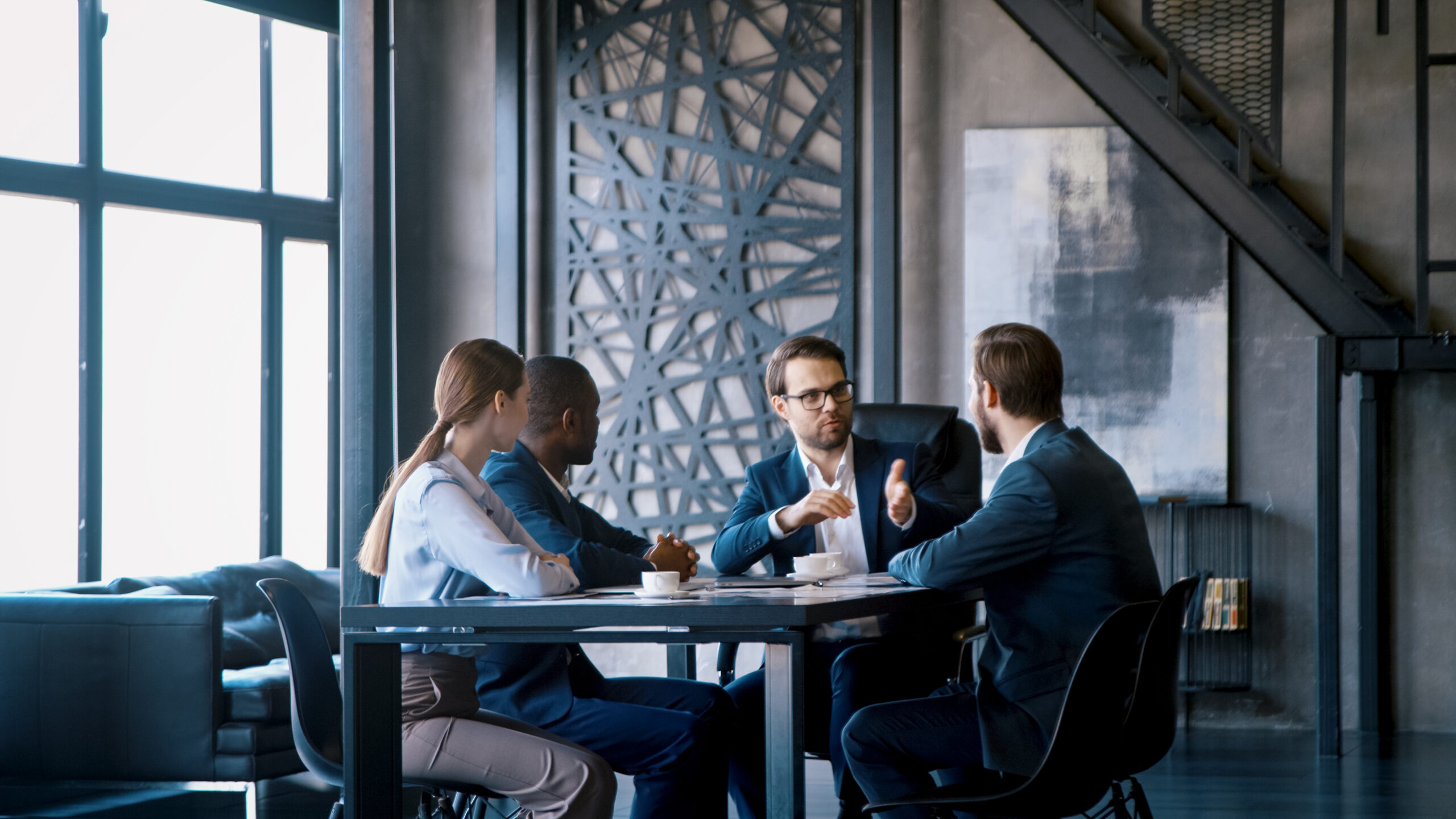 corporate manager communicating with a business team in a loft